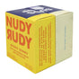 A yellow and white box of Nudy Rudy Duo 2 Pack Bar Soap features bold orange text, highlights its natural ingredients with no artificial preservatives, and the side reads: Just soap. No opera.