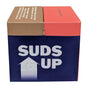 A box with a blue front labeled Nudy Rudy Duo 2 Pack Bar Soap in bold white letters and an upward arrow. Its brown and red top highlights this triple milled soap, crafted from natural ingredients.