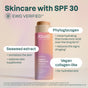 A bottle of ATTITUDE Oceanly PHYTO-SUN Tinted Face Sunscreen Oil SPF 30 with non-nano zinc oxide, phytoglycogen, seaweed extract, and vegan collagen-like benefits sits on a rock; EWG VERIFIED label is visible.