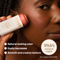 A person applies ATTITUDE Oceanly Cheeks Blush to their cheek. The image highlights its natural-looking color, blendable creamy texture, vegan and cruelty-free formula, and 99.6% natural origin ingredients.