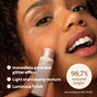 A woman applies ATTITUDE’s Oceanly Highlighter to her cheek for an instant glow and luminous, glittery finish. Its light, creamy texture glides on easily. Circular text highlights this vegan highlighter is 98.7% natural origin.
