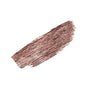 A brown brushstroke with visible bristle texture and uneven edges evokes the rich pigments of ATTITUDE’s Oceanly Mascara serum, designed to boost lash density.