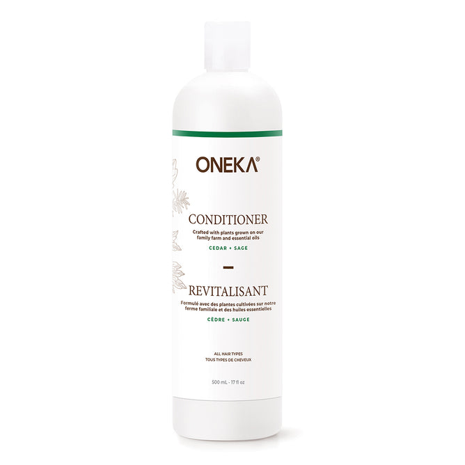 A white bottle of Oneka Conditioner - Cedar & Sage with green and gold accents, bilingual English/French text, a line drawing of leaves, and part of Oneka’s organic haircare collection.