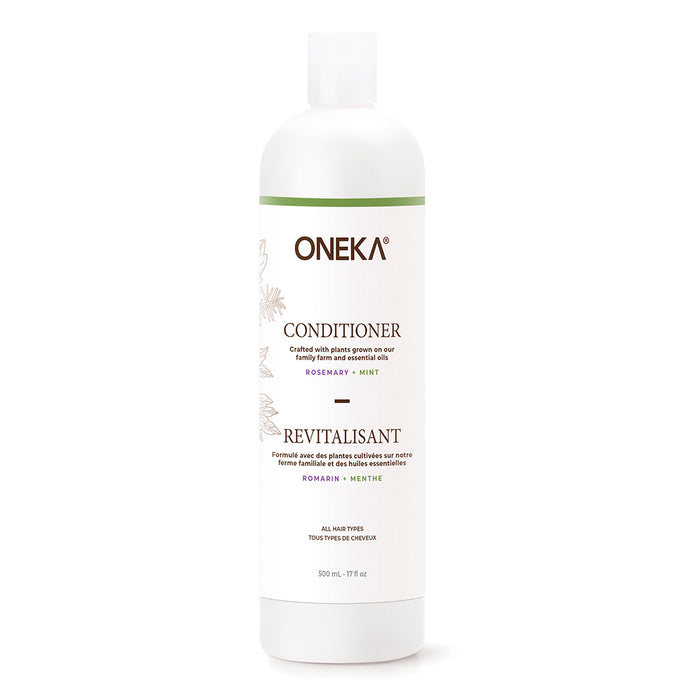 A 500 ml white bottle of Oneka Conditioner - Rosemary & Mint with a green cap and label, hydrates the scalp, is suitable for all hair types, and contains 17 fl oz.