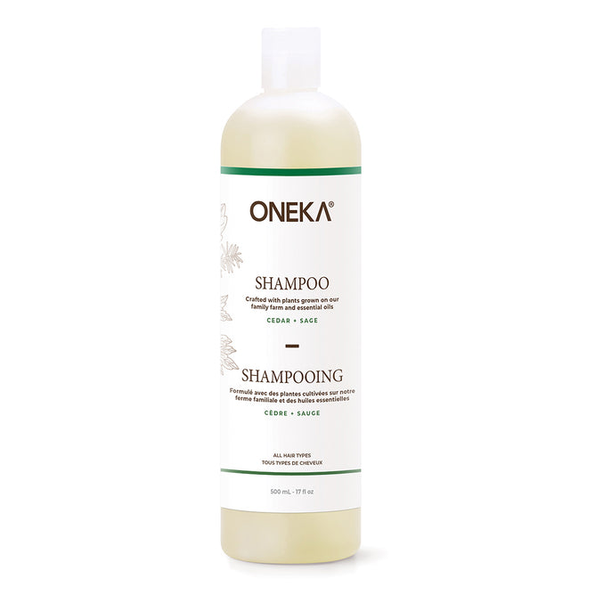 Oneka Shampoo - Cedar & Sage is a 500 mL (17 fl. oz.) organic, pH-balancing shampoo with a white label and green accents, featuring English and French text. Suitable for all hair types.