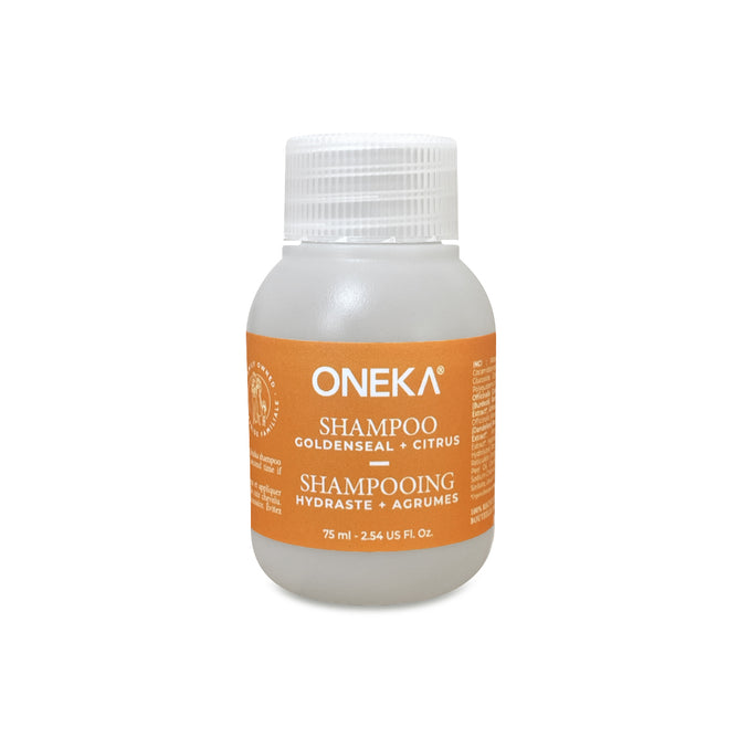 A 75 ml clear plastic bottle of Oneka Shampoo - Goldenseal and Citrus with a white cap, orange label, essential oils, and organic formula. The bilingual English/French label highlights Oneka's natural haircare commitment.