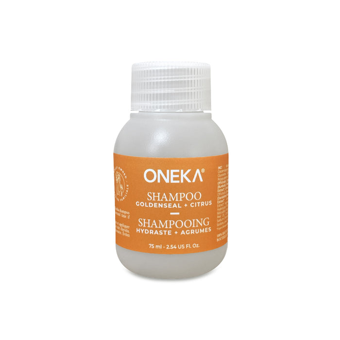 A 75 ml clear plastic bottle of Oneka Shampoo - Goldenseal and Citrus with a white cap, orange label, essential oils, and organic formula. The bilingual English/French label highlights Oneka's natural haircare commitment.