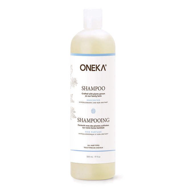 A white plastic bottle of Oneka Shampoo - Unscented features a white label with black and blue text, a clear flip-top cap, and is suitable for all hair types and sensitive scalps.