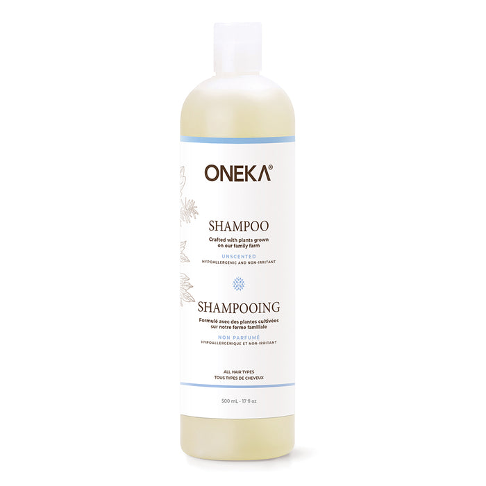A white plastic bottle of Oneka Shampoo - Unscented features a white label with black and blue text, a clear flip-top cap, and is suitable for all hair types and sensitive scalps.