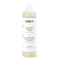 A white plastic bottle of Oneka Shampoo - Unscented features a white label with black and blue text, a clear flip-top cap, and is suitable for all hair types and sensitive scalps.