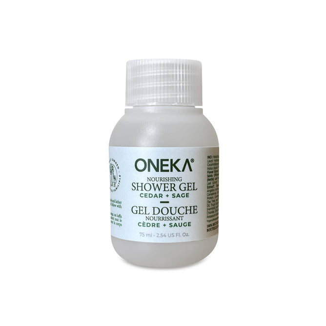 A 75 ml (2.54 fl oz) clear plastic bottle of Oneka Shower Gel - Cedar & Sage, with a white cap, pH-balancing organic formula, and bilingual labeling.