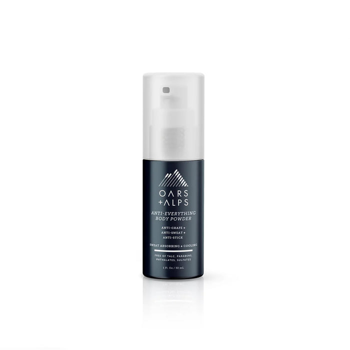 A bottle of Oars + Alps Anti-Everything Body Powder, featuring a dark blue base and translucent cap. The label notes it reduces friction, absorbs sweat, and fights chafing and odor.