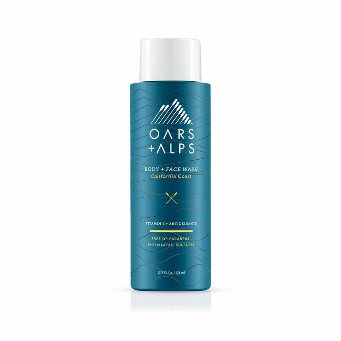 A teal bottle of Oars + Alps Cali Coast Body Wash with white text and a mountain logo. The label notes Vitamin E, antioxidants, and that it’s free of parabens, phthalates, and sulfates.