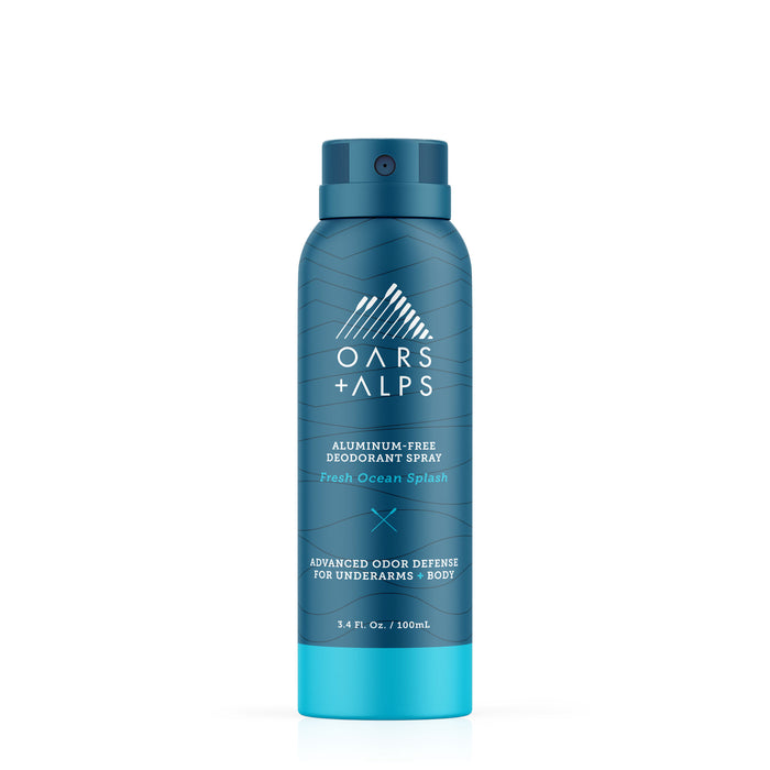 A blue 3.4 fl. oz. Oars + Alps Spray Deodorant in Fresh Ocean Splash scent features a white geometric mountain logo and offers extra-strength, aluminum-free odor defense for underarms and body in a travel-friendly size.