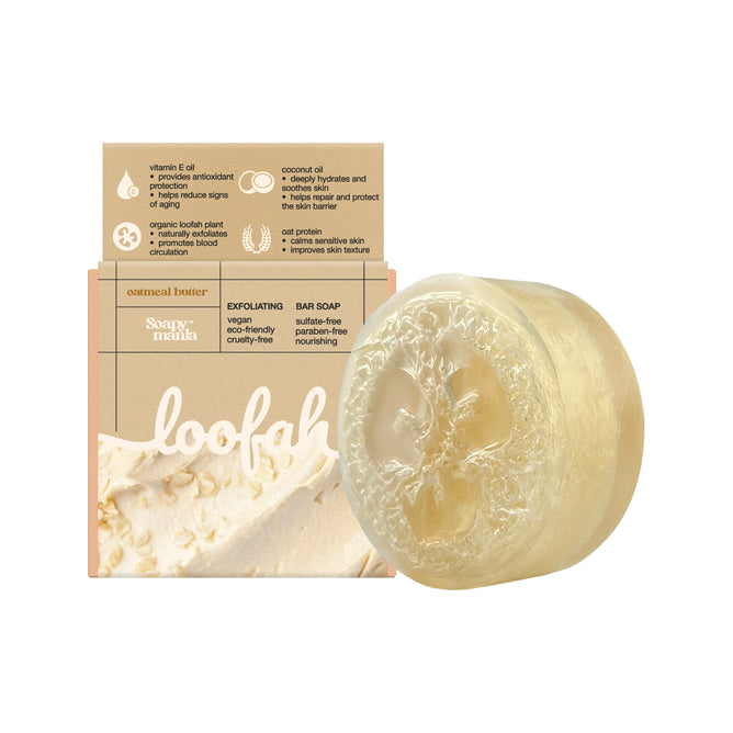 The Soapymania Oatmeal Butter Exfoliating Loofah Bar Soap is a round, translucent oatmeal bar with a visible natural loofah inside, displayed before beige packaging featuring oats and product details.