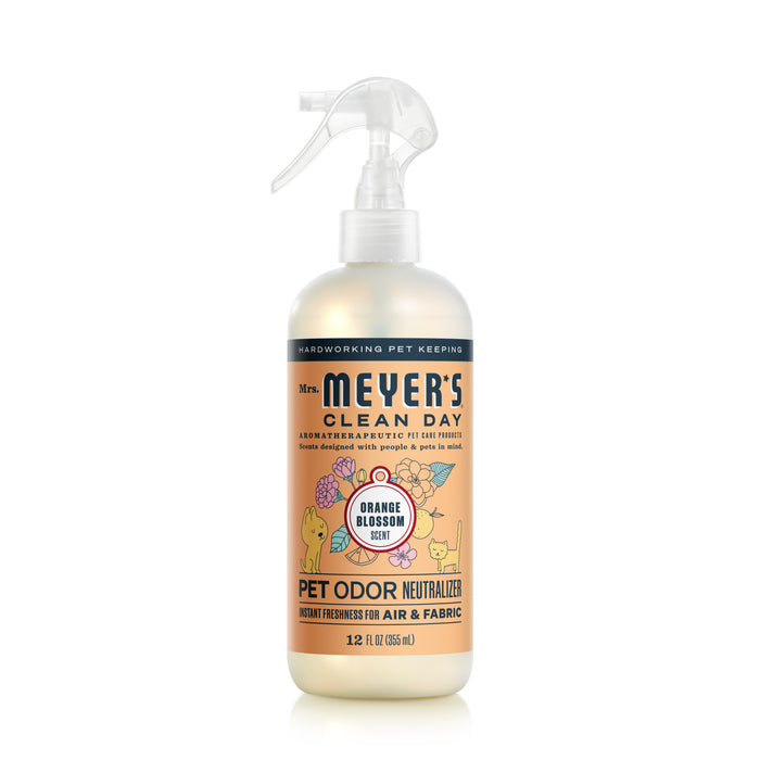 A 12-fluid ounce spray bottle of Mrs. Meyers Odor Neutralizer in Orange Blossom scent features a floral and pet-themed label, showcasing its powerful formula to eliminate pet odors in air and fabric.