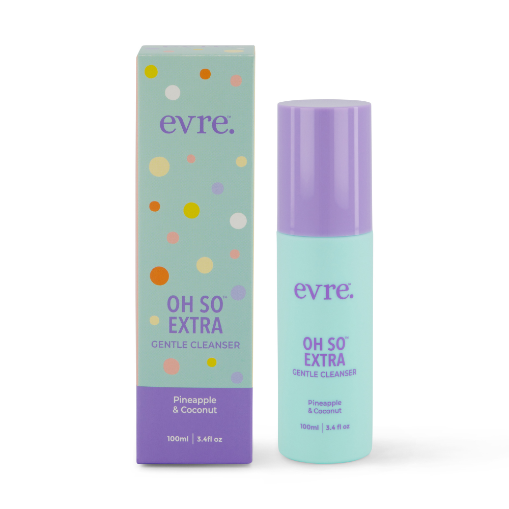 The image features a turquoise and purple bottle of evres Oh So Extra Pineapple & Coconut Face Cleanser alongside its matching box. The 100ml (3.4 fl oz) cleanser, enriched with pineapple extract and coconut scent, promises an indulgently gentle experience.