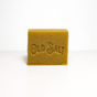 A rectangular brown Hair/Beard Shampoo bar by Old Salt stands upright on a white surface, with "OLD SALT" engraved on the front against a plain background.