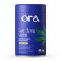 A blue cylindrical Ora Organic container labeled "Easy Being Green: Daily Active Superfood Greens Powder, Citrus Flavor," features green leaf graphics, certification icons, and highlights organic prebiotics on the front.