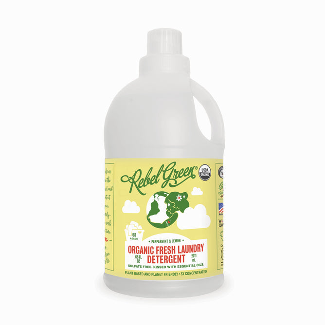 A bottle of Rebel Green Fresh Laundry Detergent Liquid - 3x Concentrated features a yellow label with green silhouettes, highlighting its peppermint lemon scent and eco-friendly, plant-based formula.