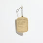 A P.F. Candle Co. Car Freshener, shaped like a candle jar and hanging by a black string, is shown against a white background—delivering an instant fresh atmosphere with minimal packaging waste.