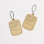 Two tan, jar-shaped Car Fresheners from P.F. Candle Co., with black outlines and labeled No. 32: Sandalwood Rose, hang by black strings and offer an instant atmosphere boost on a white background.