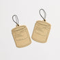 Two brown, candle-shaped Car Fresheners by P.F. Candle Co. with black strings are shown against a white background, inspired by California and designed to instantly refresh your atmosphere.