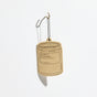 A beige Car Freshener by P.F. Candle Co., shaped like a candle jar and hanging from a black string on a metal hook. The label reads Los Angeles Air Freshener, Designed in California—an atmosphere boost with minimal packaging waste.