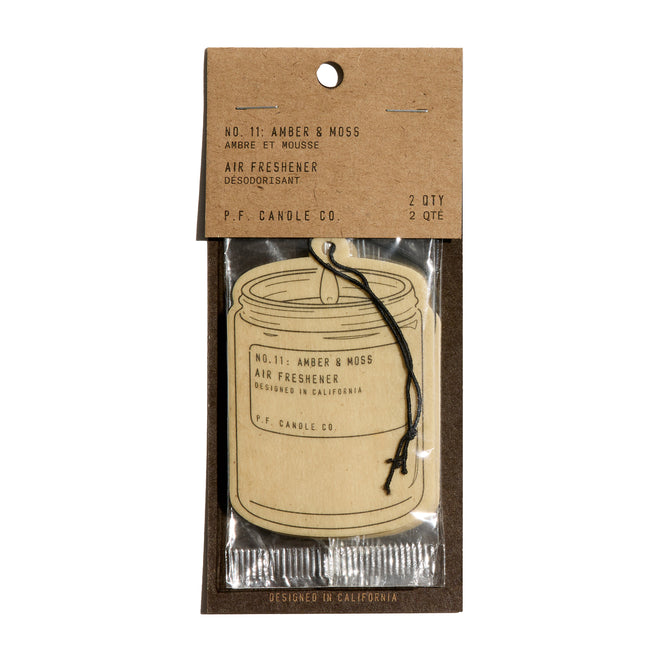 The P.F. Candle Co. Car Freshener in No. 11: Amber & Moss scent, shaped like a jar and packaged with minimal waste, delivers an instant atmosphere boost with eco-friendly packaging.