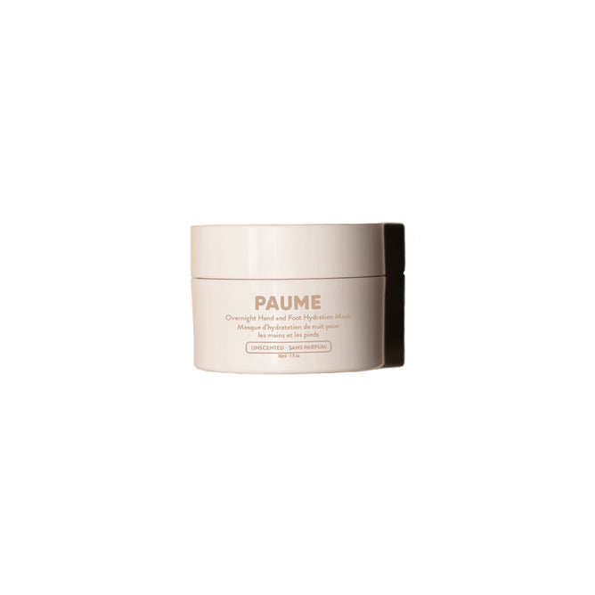 A beige jar of PAUME Mini Overnight Hand and Foot Hydration Mask sits centered on a white background, featuring text that highlights its shea butter formula for hydrating dry, cracked skin.