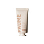 A beige tube of PAUME Probiotic Hand Balm stands upright on a white background, featuring English and French text. This hand balm provides lasting hydration for dry, chapped hands.
