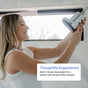 A woman smiles as she adjusts the Rorra Filtered Showerhead in a bright bathroom. A text box reads: Thoughtful Ergonomics. The Rorra showerhead features a built-in thread-stop system for a perfect seal and quick filter changes, ensuring effective chlorine reduction with every use.