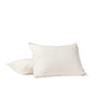 Two white pillows are displayed against a plain white background—one upright and the other lying flat just behind it—both encased in Coyuchi’s Organic Crinkled Percale™ Sham, crafted from breathable GOTS Certified organic cotton.