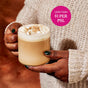 A person in a cream sweater holds a glass mug of pumpkin spice latte topped with whipped cream and fresh Diaspora Spice Co. Pumpkin Spice Blend. A pink circle reads Less than $1 per PSL.