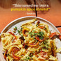A plate of fettuccine pasta with roasted pumpkin, herbs, and seeds sits on a tan surface. Text above reads, This turned me into a pumpkin spice convert – Sarah M. Made with Diaspora Spice Co.’s Pumpkin Spice Blend, this dish delivers the perfect harmony of savory and aromatic flavors for an unforgettable autumn meal.
