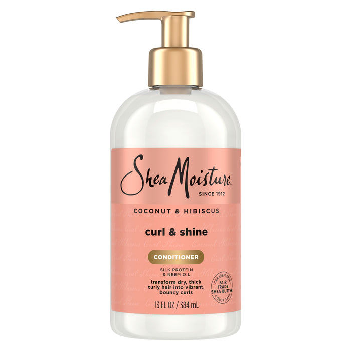 A 13 fl oz (384 ml) bottle of SheaMoisture Conditioner - Curl + Shine with a gold pump, specifically formulated to deliver curl definition and shine while taming frizz for those with thick, curly hair.
