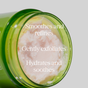 A green jar of Andalou Naturals Resurfacing Gentle Glycolic Scrub sits against a gray background, revealing light pink cream inside. The jar reads: "Smoothes and refines, gently exfoliates, hydrates and soothes." Infused with lactic acid and glycolic acid, this exfoliating scrub leaves skin feeling fresh and rejuvenated.