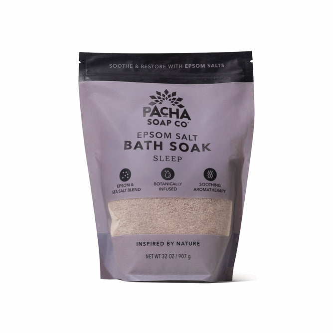 A 32 oz (907 g) lavender and tan pouch of Pacha Soap Co. Sleep Epsom Salt Bath Soak, featuring botanically infused aromatherapy and a calming Epsom and sea salts blend for a soothing bath experience.