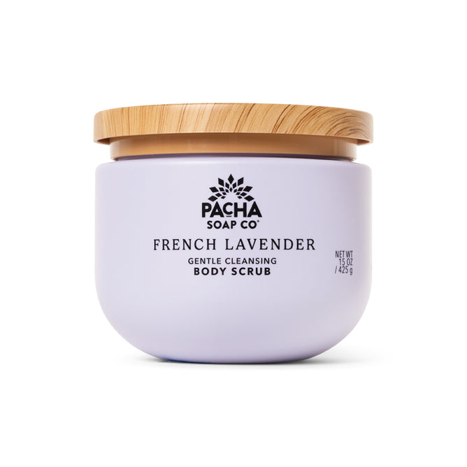 A lavender jar of Pacha Soap Co. Body Scrub with a whipped texture and light wooden lid is displayed against a white background.