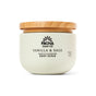 Pacha Soap Co. Body Scrub features a creamy, whipped texture in a light jar with black text and a wooden lid—a gentle exfoliant for soft, radiant skin.