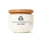 A 15.8 oz white jar of Pacha Soap Co. Body Scrub with a wooden lid and minimalist black text label, this gentle exfoliant hydrates skin with a White Blossom & Fig scent.