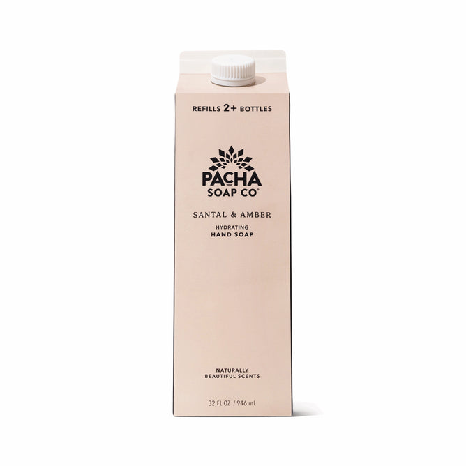 A beige 32 fl oz Pacha Soap Co. Hand Soap Refill carton with Santal & Amber scent, enriched with hydrating shea butter and naturally beautiful scents. The sustainable carton with white cap refills 2+ bottles.