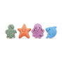 Four colorful toy sea animals—a green turtle, orange starfish, purple octopus, and blue shark—smile brightly against a white background, perfect to pair with Pacha Soap Co. Bar Soap Buddies for gentle cleansing fun.