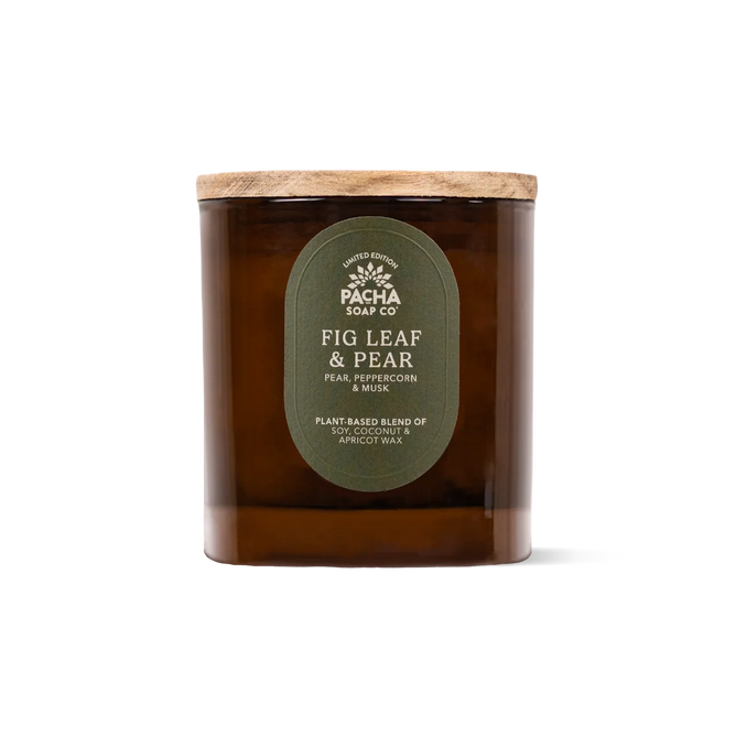A brown amber glass jar soy coconut apricot candle with a wooden lid, labeled Pacha Soap Co. Fall Signature Candle, features house-designed Fig Leaf & Pear fragrance notes of pear, peppercorn, and musk. The plant-based wax blend ensures a clean-burning experience.
