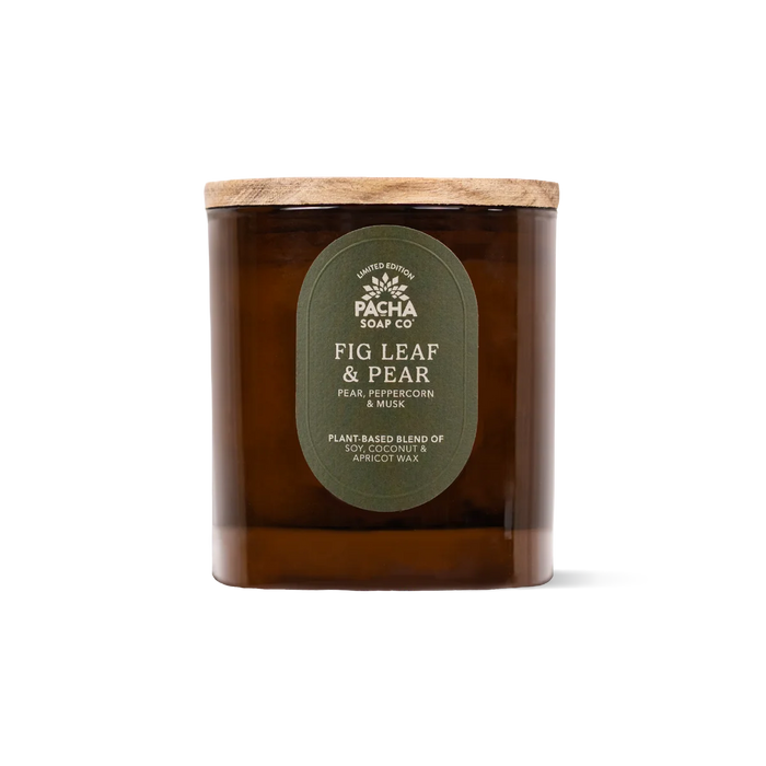 A brown amber glass jar soy coconut apricot candle with a wooden lid, labeled Pacha Soap Co. Fall Signature Candle, features house-designed Fig Leaf & Pear fragrance notes of pear, peppercorn, and musk. The plant-based wax blend ensures a clean-burning experience.