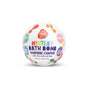 A colorful, round Mystery Bath Bomb by Pacha Soap Co. features a fruity scent and has illustrations of question marks and fruit names—Apple, Berry, Watermelon—on its white label.