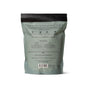 Back view of a green and black resealable pouch of Pacha Soap Co. Salt Soak, showing printed directions, ingredients such as mineral-rich magnesium flakes, and company info. The bag stands upright on a white background.