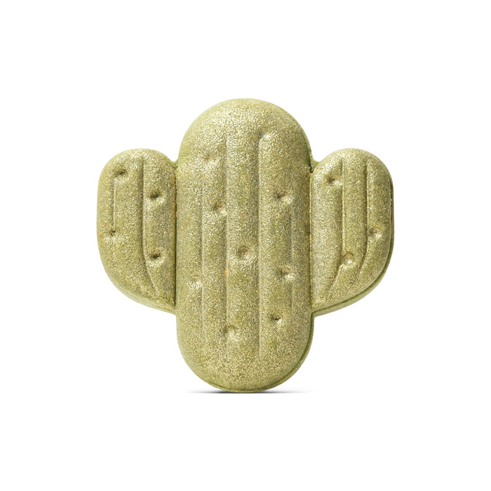 A gold, glittery Santal & Amber Bath Bomb by Pacha Soap Co., shaped like a three-armed cartoon saguaro cactus, evokes playful charm and promises a soothing bath, set against a plain white background.