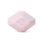 A single, light pink, hexagonal Sleep Epsom Salt Bath Bomb by Pacha Soap Co., featuring beveled edges and an embossed leaf design—perfect for aromatherapy—displayed against a white background.