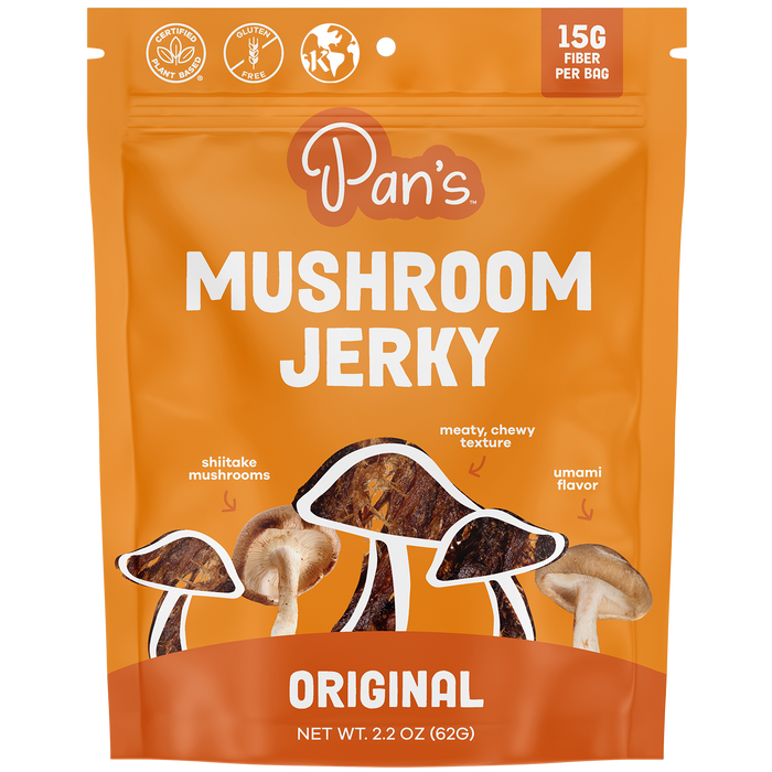 Pans Original Mushroom Jerky features a vibrant orange package displaying shiitake mushrooms and jerky strips. It boasts 15G Fiber Per Bag, a meaty, chewy texture, and rich umami flavor, along with gluten-free and vegan icons for conscious snacking.